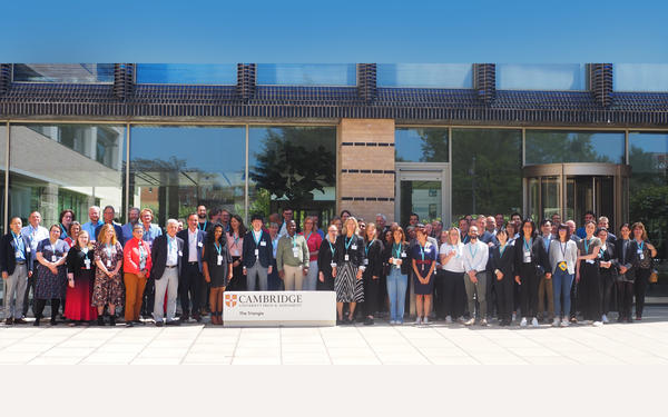 FLIP+ members stand outside the Triangle building for a group photo at the FLIP+ global e assessment event 2023 held in Cambridge