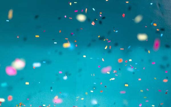 Confetti falling on a blue background