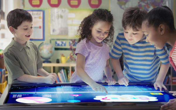 Children looking at interactive table
